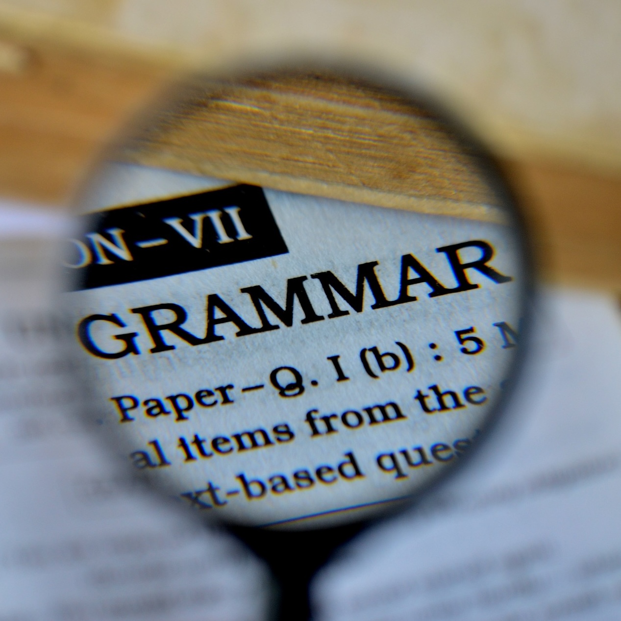 A magnifying glass focussed on the word Grammar.